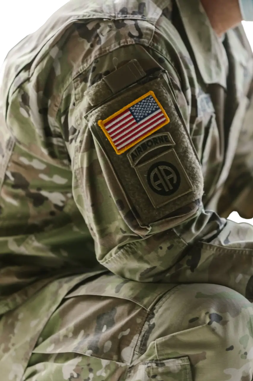 Picture of a smiling veteran with tiny house in the palm of his hand.